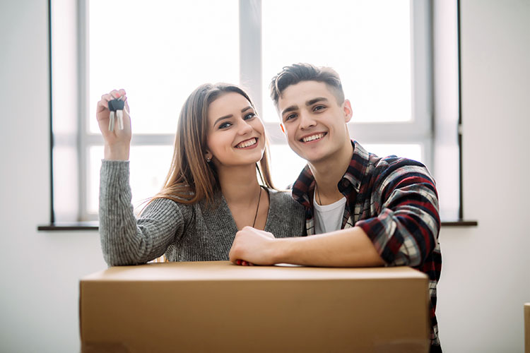 Picture of young couple holding keys